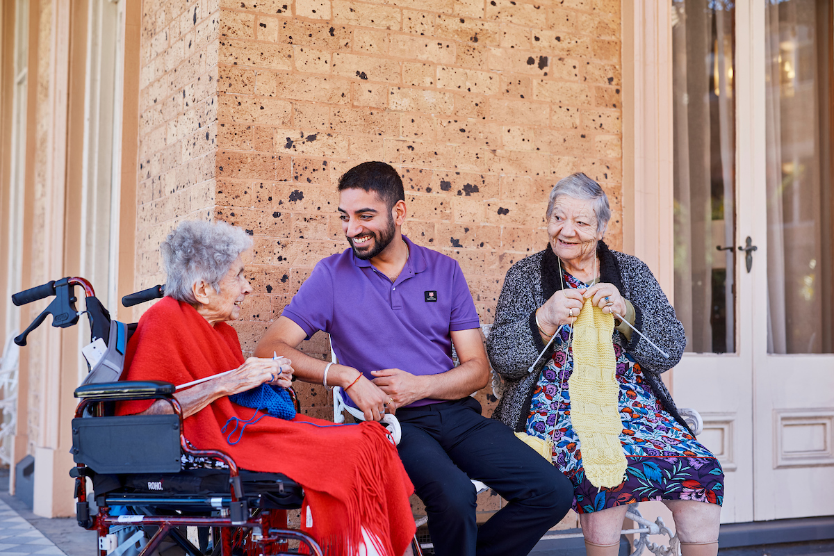 Home Care Worker helping with the dishes in client's own home. 