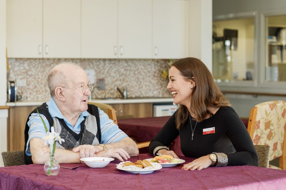 Salvos aged care team member with a resident